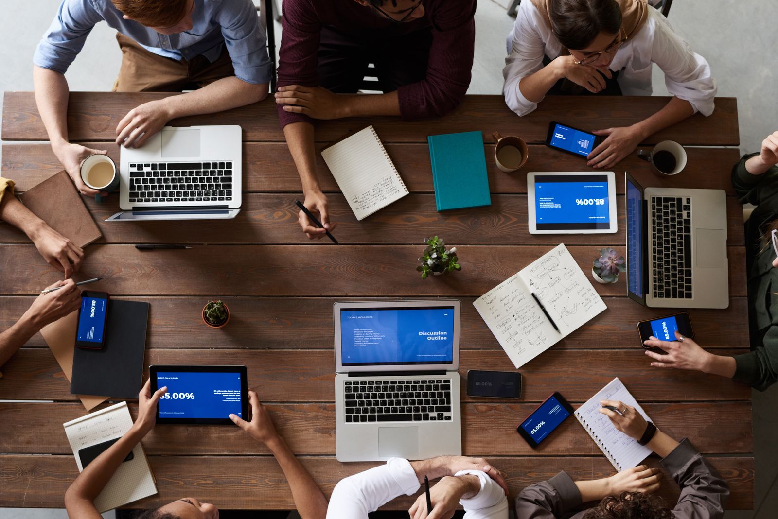 A team working together over laptops and notes